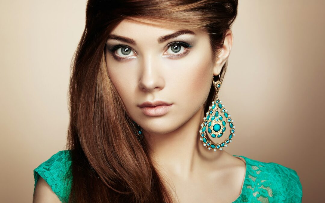 Portrait of beautiful young woman with earring. Jewelry and acce