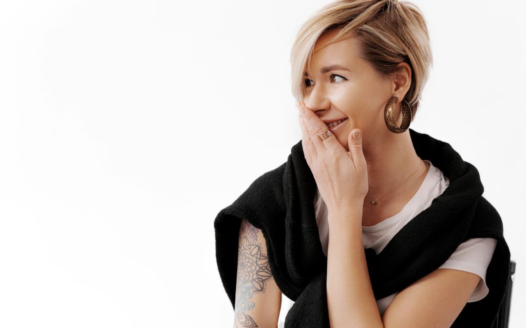 Smiling woman wearing stylish earring and black jacket